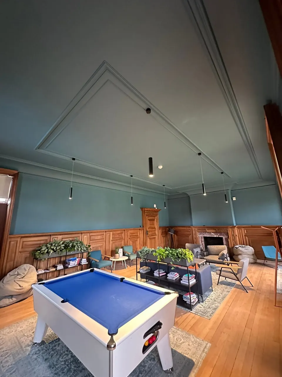 Games room with blue-green walls and timber panelling