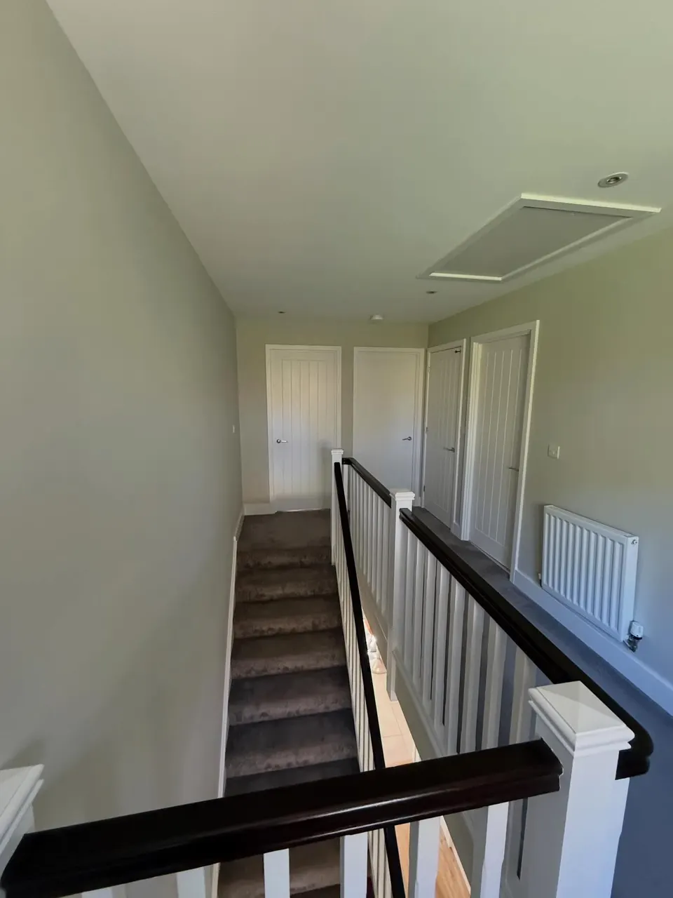Landing and stairwell walls painted in pale sage