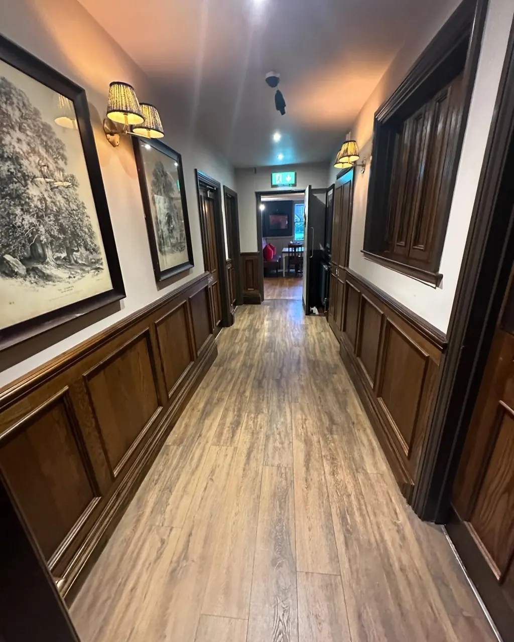 Corridor with painted trim and dark wood panelling