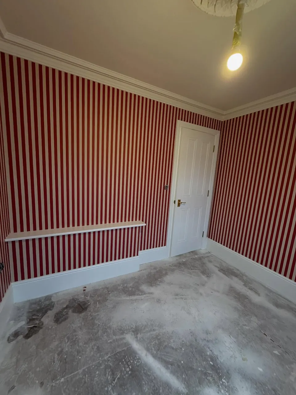 Red and white striped wallpaper hung with straight, matched seams