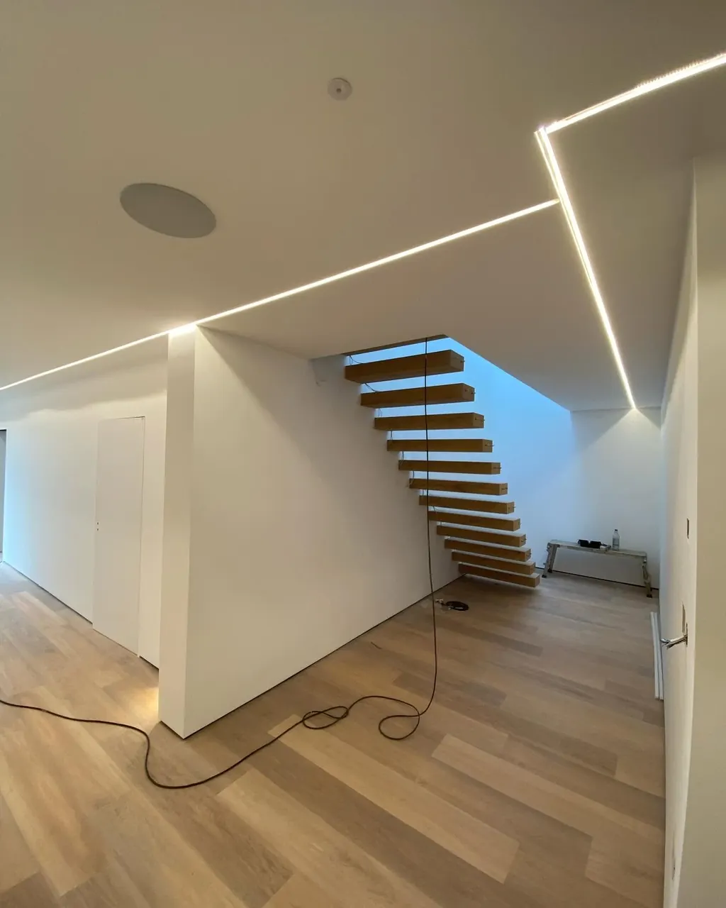 Modern interior with floating stairs and newly painted walls