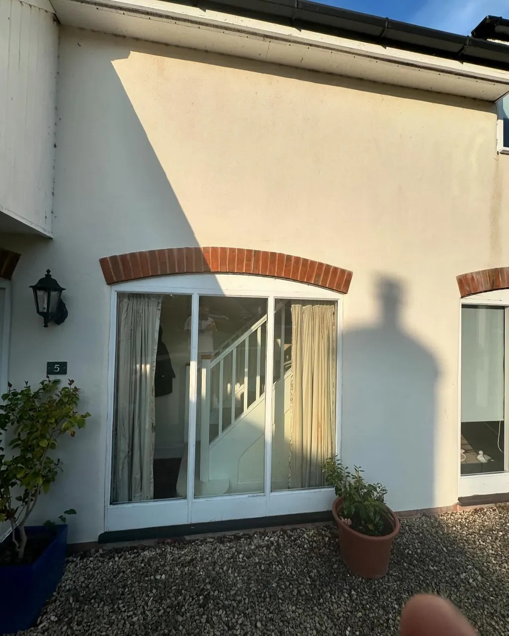 Freshly coated white exterior render around windows