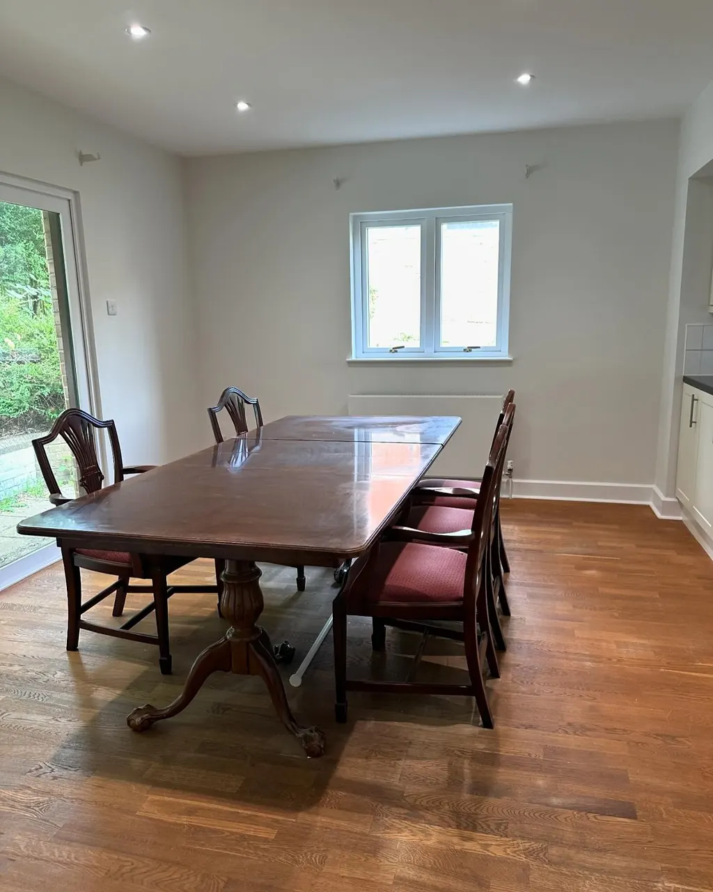 Dining room interior decorating with pale walls and garden windows