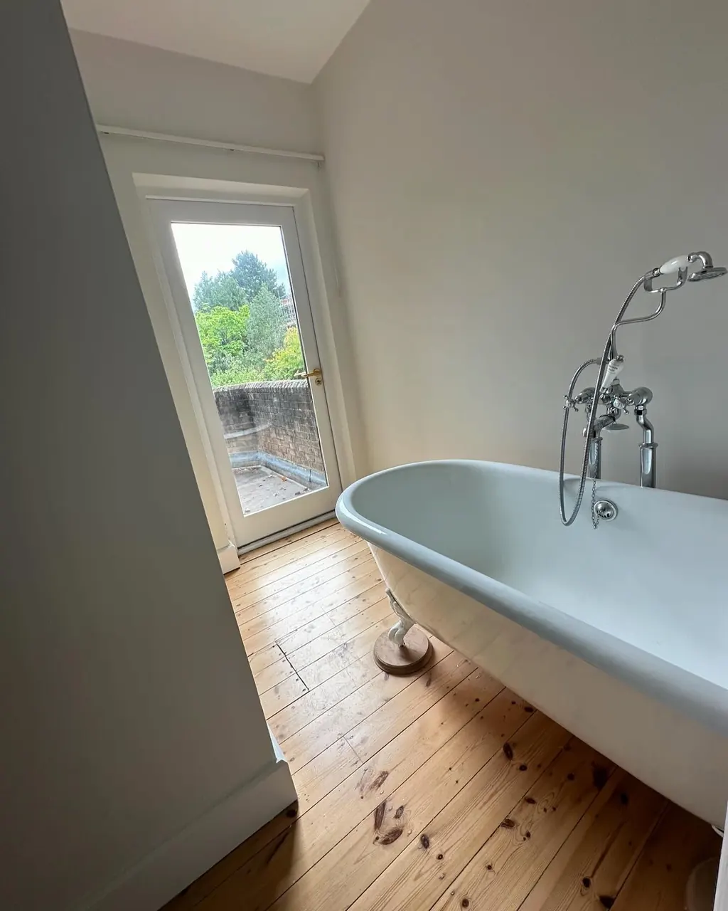 Bathroom painted white around a freestanding bath