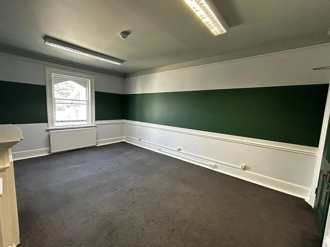 Green and white decorated room with dado rail