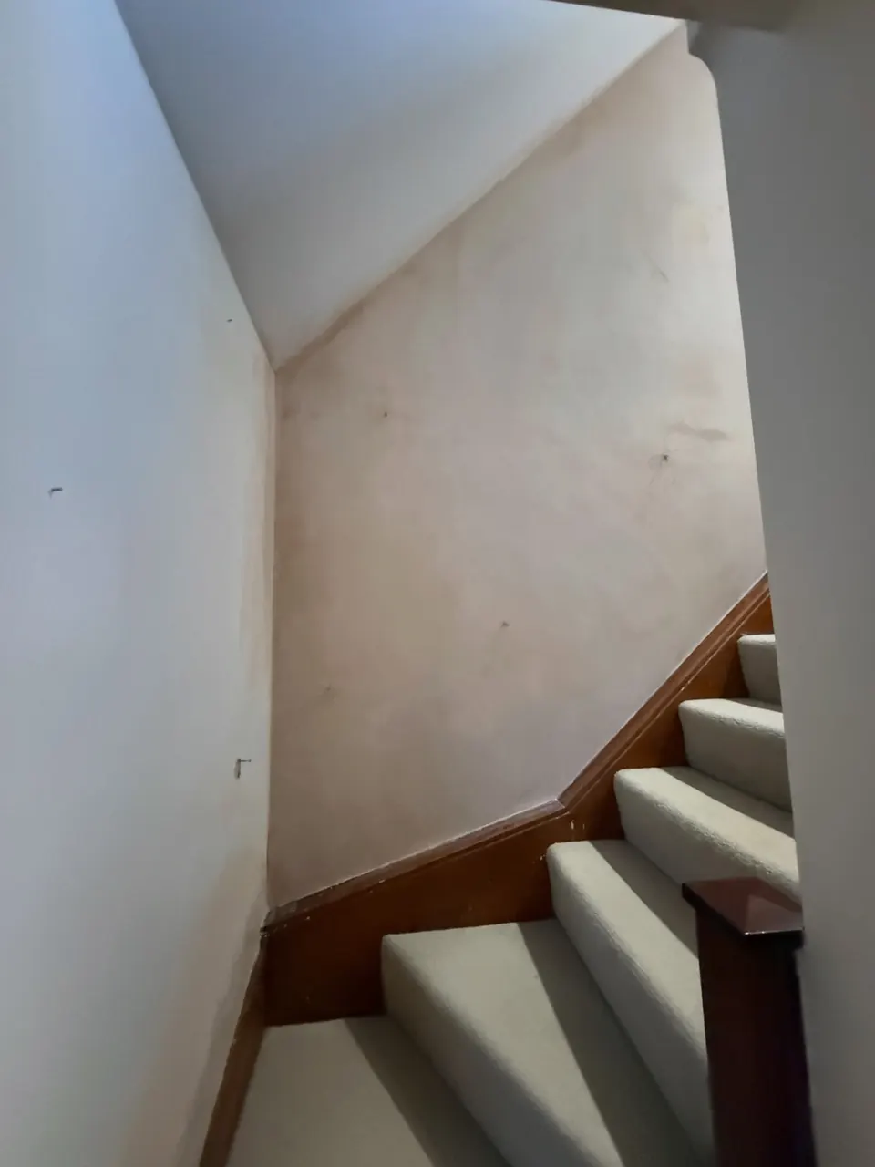Marked stairwell wall before redecoration